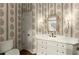 Stylish powder room with custom wallpaper, vanity and modern sink at 311 Rolling Rock Se Rd, Marietta, GA 30067