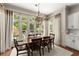 Elegant dining room with large windows overlooking the yard at 311 Rolling Rock Se Rd, Marietta, GA 30067