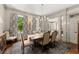 Dining room with hardwood floors, decorative rug and large windows for natural light at 311 Rolling Rock Se Rd, Marietta, GA 30067