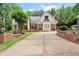 Beautiful two-story brick home with manicured landscaping and a long driveway at 311 Rolling Rock Se Rd, Marietta, GA 30067