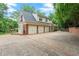 Spacious two-story brick home with a three-car garage and a concrete driveway at 311 Rolling Rock Se Rd, Marietta, GA 30067