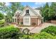 Stunning two-story brick home with an attached garage and manicured landscaping in a suburban neighborhood at 311 Rolling Rock Se Rd, Marietta, GA 30067