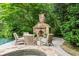 Stone fireplace with outdoor seating overlooking the pool and spa at 311 Rolling Rock Se Rd, Marietta, GA 30067