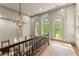 Light-filled foyer with high ceilings, statement chandelier, and large arched windows at 311 Rolling Rock Se Rd, Marietta, GA 30067
