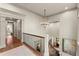 Bright foyer with chandelier features access to upper level and bedroom down the hallway at 311 Rolling Rock Se Rd, Marietta, GA 30067
