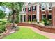 Beautiful brick home with manicured lawn, walkway, a balcony, and black shutters on the windows at 311 Rolling Rock Se Rd, Marietta, GA 30067