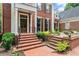 Charming brick home with a beautiful front porch and steps leading up to the entrance at 311 Rolling Rock Se Rd, Marietta, GA 30067