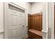 This hallway features a wooden coat rack with seat adjacent to a white door at 311 Rolling Rock Se Rd, Marietta, GA 30067