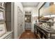 Hallway with hardwood floors, decorative console and view into powder room at 311 Rolling Rock Se Rd, Marietta, GA 30067