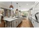 Open concept kitchen featuring a large kitchen island with hardwood flooring and modern lighting at 311 Rolling Rock Se Rd, Marietta, GA 30067