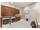 Spacious laundry room features washer and dryer, wood cabinets, and utility sink at 311 Rolling Rock Se Rd, Marietta, GA 30067