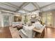 Bright, open living room with coffered ceilings, fireplace, and large windows at 311 Rolling Rock Se Rd, Marietta, GA 30067
