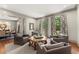 Elegant living room features stylish seating, patterned curtains, and a view into the dining area at 311 Rolling Rock Se Rd, Marietta, GA 30067