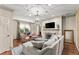 Cozy living room with fireplace, TV, elegant furniture, and views of the outdoors at 311 Rolling Rock Se Rd, Marietta, GA 30067