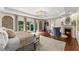 Spacious main bedroom with hardwood floors, fireplace, elegant lighting and balcony access at 311 Rolling Rock Se Rd, Marietta, GA 30067