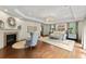 Bright main bedroom showcases hardwood floors, fireplace, tray ceiling, and generous natural light at 311 Rolling Rock Se Rd, Marietta, GA 30067