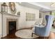 Cozy seating area with fireplace and hardwood floors offer a relaxing retreat at 311 Rolling Rock Se Rd, Marietta, GA 30067