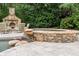 Stone spa with a waterfall feature, providing a luxurious outdoor experience at 311 Rolling Rock Se Rd, Marietta, GA 30067