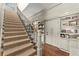 Carpeted staircase with custom built-in shelving and trim at 311 Rolling Rock Se Rd, Marietta, GA 30067
