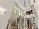 Staircase with high ceilings, arched windows, and a view to the living room at 311 Rolling Rock Se Rd, Marietta, GA 30067