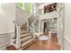 Elegant staircase with natural light, hardwood floors, and an open view to the living room at 311 Rolling Rock Se Rd, Marietta, GA 30067