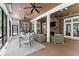 Relaxing sunroom with brick fireplace, wall-mounted TV, ample seating, and outdoor access at 311 Rolling Rock Se Rd, Marietta, GA 30067