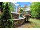 Outdoor waterfall feature with stone accents surrounded by mature trees at 311 Rolling Rock Se Rd, Marietta, GA 30067