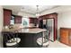 Wet bar with granite counters, tile backsplash, stainless fridge and seating for entertaining at 311 Rolling Rock Se Rd, Marietta, GA 30067