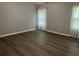 Bright bedroom featuring gray walls, wood-look flooring, and ample natural light at 519 Granite Nw Ct, Lawrenceville, GA 30044