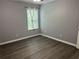 Bedroom featuring gray walls, wood-style flooring, and a window at 519 Granite Nw Ct, Lawrenceville, GA 30044
