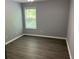 Bedroom featuring gray walls, wood-style flooring, and a window at 519 Granite Nw Ct, Lawrenceville, GA 30044
