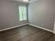 Bedroom showing a gray painted wall with a window dressed with curtains that filter natural light at 519 Granite Nw Ct, Lawrenceville, GA 30044