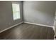 Bedroom featuring gray walls, wood-style flooring, and a window at 519 Granite Nw Ct, Lawrenceville, GA 30044