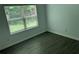 A bright bedroom featuring hardwood flooring, a large window, and natural light at 519 Granite Nw Ct, Lawrenceville, GA 30044