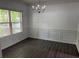 Elegant dining room featuring dark wood-look floors, chair rail, and a modern chandelier at 519 Granite Nw Ct, Lawrenceville, GA 30044