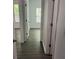 Hallway features dark wood-look flooring, neutral paint, and access to other rooms at 519 Granite Nw Ct, Lawrenceville, GA 30044