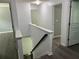 Hallway with dark floors leading to bedrooms and stairwell at 519 Granite Nw Ct, Lawrenceville, GA 30044