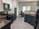 Stylish kitchen with granite countertops, dark cabinets, stainless appliances, and an adjacent dining area at 519 Granite Nw Ct, Lawrenceville, GA 30044