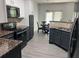 Stylish eat-in kitchen featuring granite counters, stainless appliances, and wood-look flooring at 519 Granite Nw Ct, Lawrenceville, GA 30044