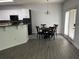 Bright kitchen area with white cabinets, granite countertops, and seating for four at 519 Granite Nw Ct, Lawrenceville, GA 30044