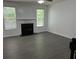 Comfortable living room featuring dark wood-look flooring, a fireplace, and lots of natural light at 519 Granite Nw Ct, Lawrenceville, GA 30044