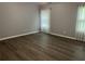 Large bedroom with hardwood flooring, ceiling fan, and two windows with curtains at 519 Granite Nw Ct, Lawrenceville, GA 30044