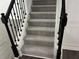 Carpeted staircase with black metal railings and white trim at 519 Granite Nw Ct, Lawrenceville, GA 30044