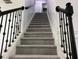 Carpeted staircase with black metal railings and white trim at 519 Granite Nw Ct, Lawrenceville, GA 30044