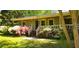 Charming home featuring a quaint front porch and a garden filled with blooming azaleas, showcasing natural beauty at 61 Maxie Ln, Dallas, GA 30157