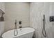 Soaking tub with sleek black fixtures and neutral toned shower tile at 2809 Glenwood Se Ave, Atlanta, GA 30317