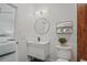 Bright bathroom featuring a sleek vanity, round mirror, and stylish wood-look tile at 2809 Glenwood Se Ave, Atlanta, GA 30317