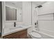 A contemporary bathroom features a shower and tub combo and unique wood-look vanity at 2809 Glenwood Se Ave, Atlanta, GA 30317