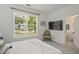 Bright bedroom offers a large window with green outdoor views and ensuite access at 2809 Glenwood Se Ave, Atlanta, GA 30317