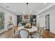 A dining area with wood floors featuring a large table with chairs adjacent to the kitchen at 2809 Glenwood Se Ave, Atlanta, GA 30317